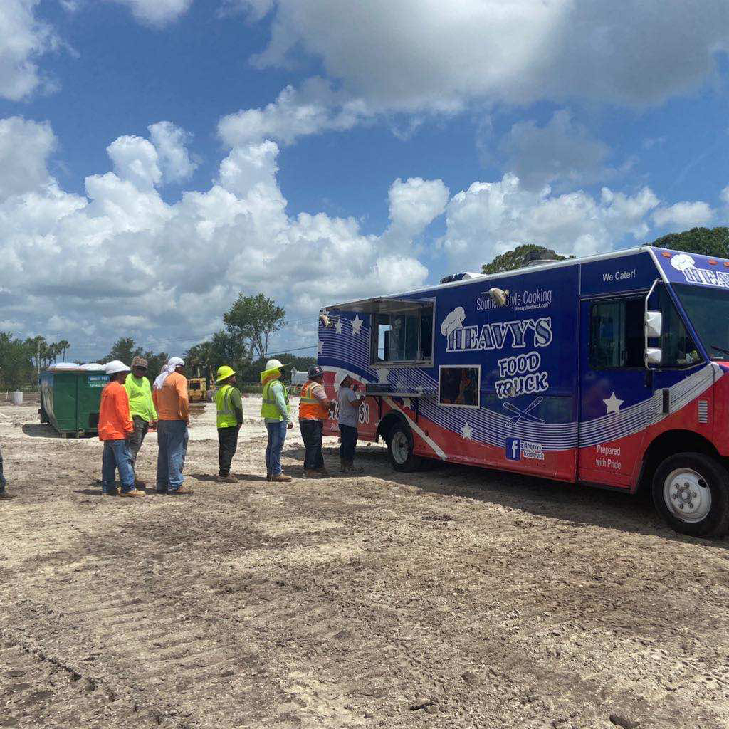 construction crew for coastal orthopedics in line of a food truck