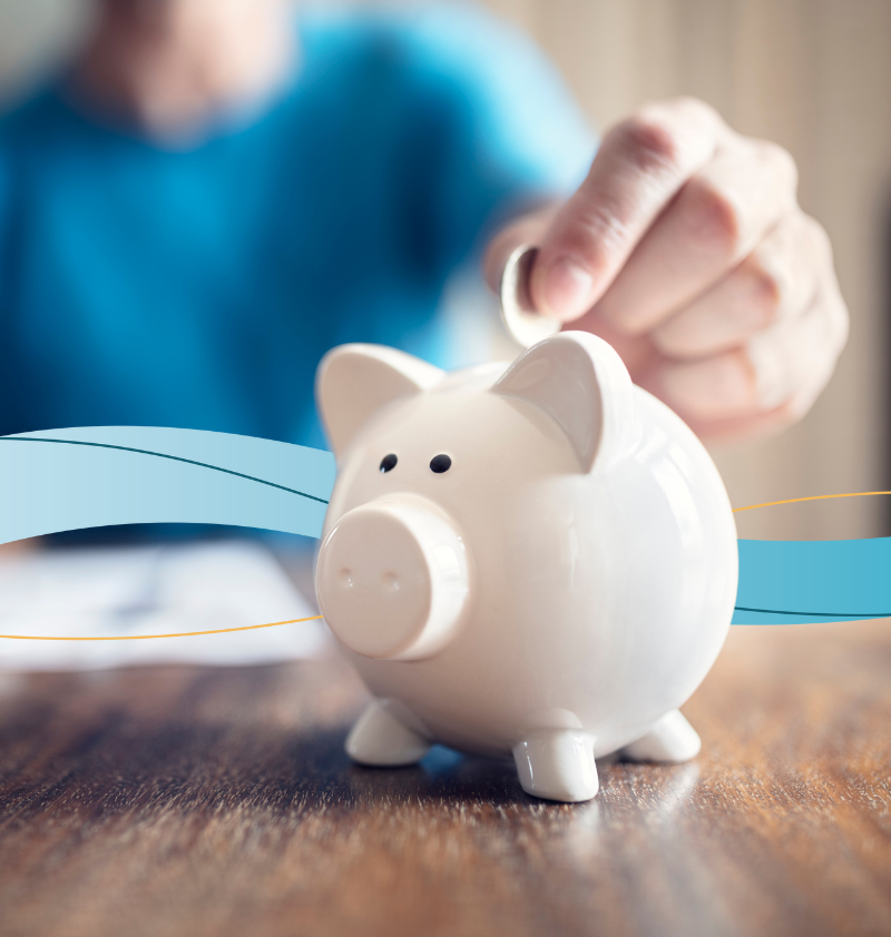 Person putting coin into Piggy Bank