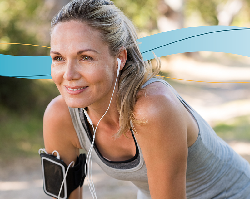 woman outside riding bike with headset on 