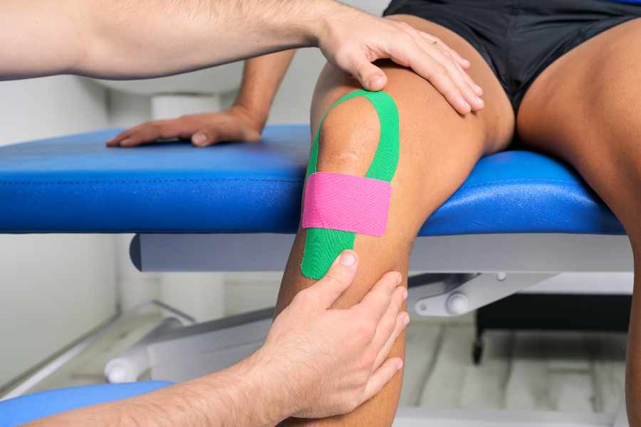 Kinesio tape being applied to knee