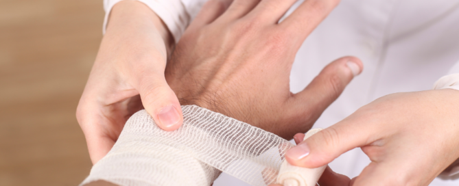 Medical professional wrapping patient wrist in bandage