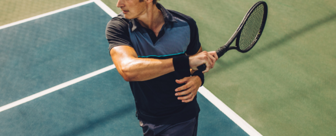 man playing tennis swining racket