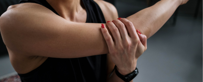 woman stretching arm and shoulder holding elbow