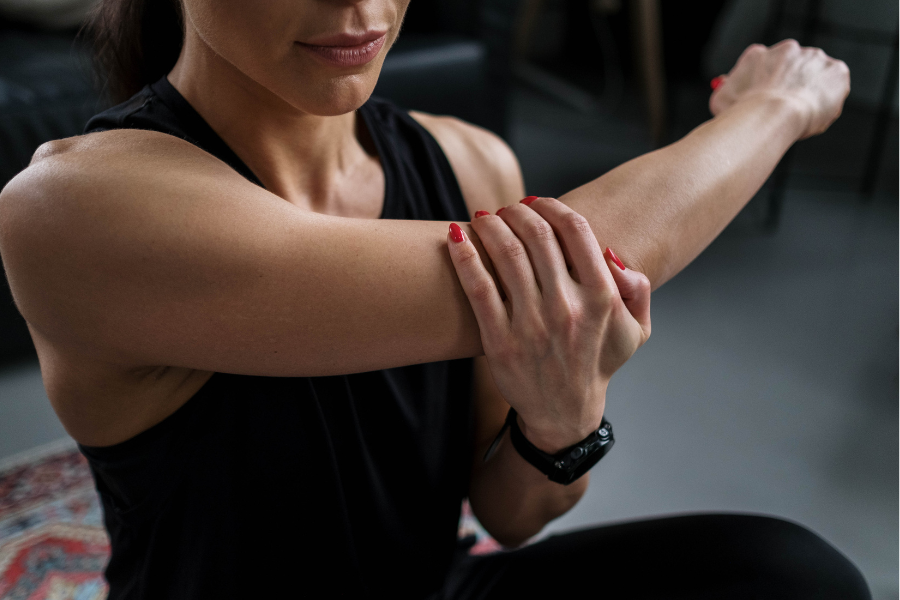 woman stretching arm and shoulder holding elbow