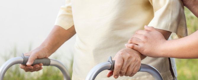 senior person with walker being assisted by nurse