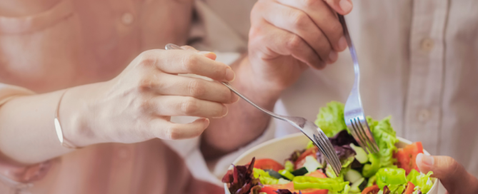 two people sharing a salad