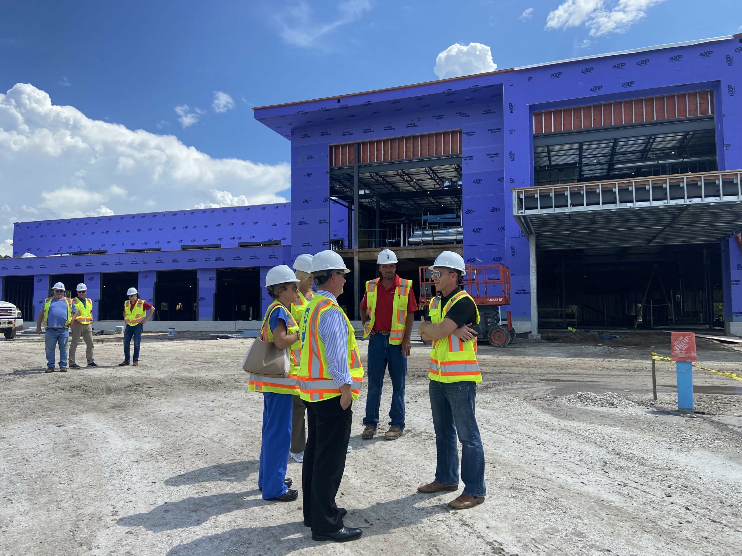 Construction site manages consult with Coastal Orthopedics staff updating about new location build