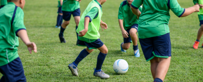 children playing a game of soccer