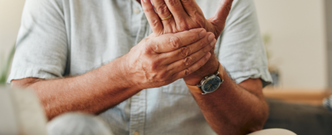 senior citizen holdigng wrist in pain