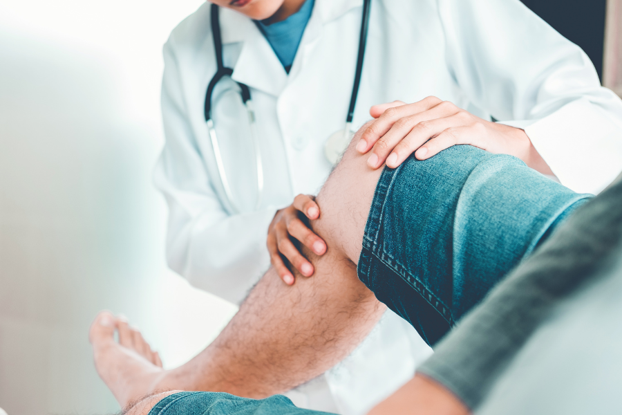 medical professional examining patient knee