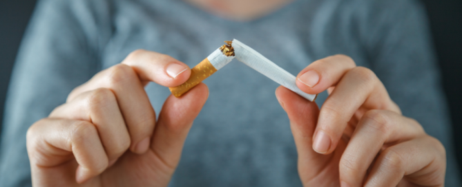 Woman breaking cigarette in half