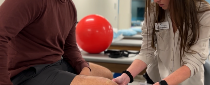 physical therapist examing patient leg and knee