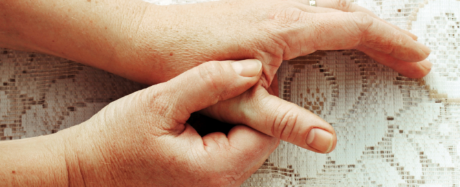 Person massaging their thumb joint