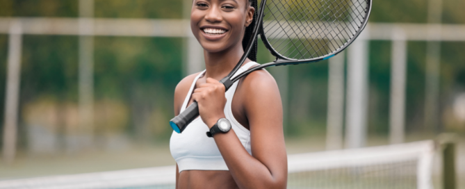 woman at tennis court holding tennis racket