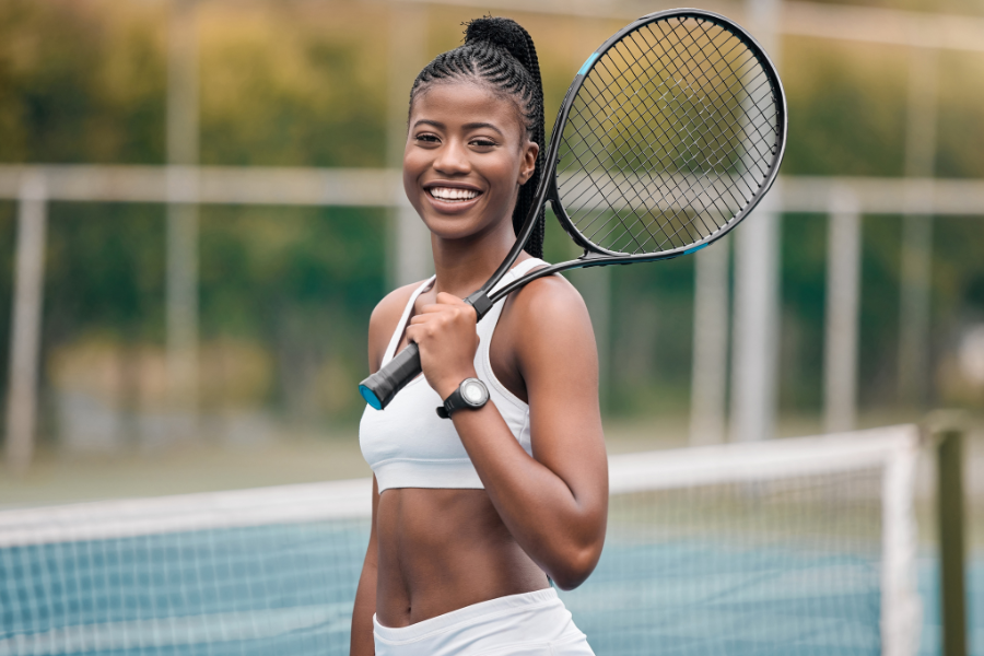 woman at tennis court holding tennis racket