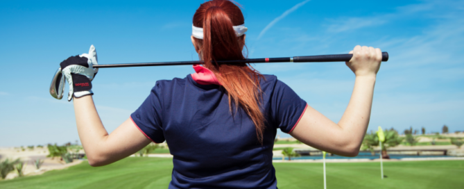 golfer holding golf club across back